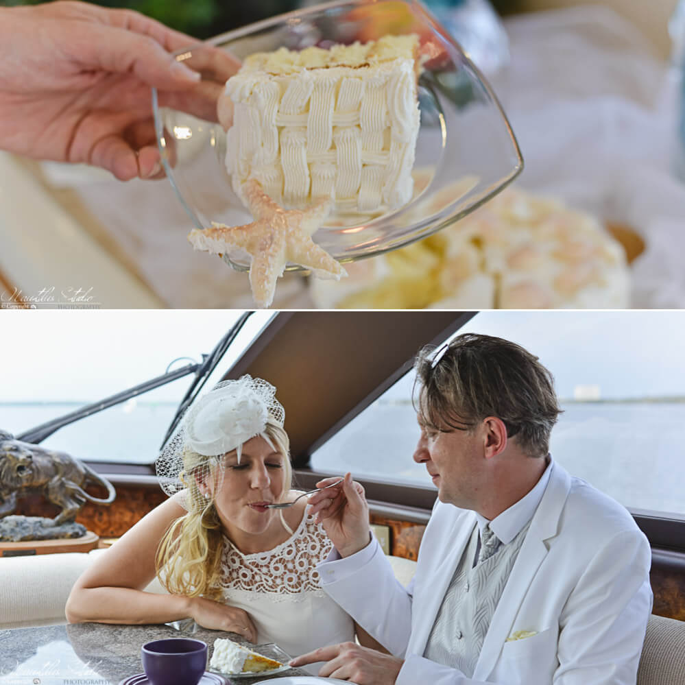 Brautpaar genießt Hochzeittorte auf ihrer Yacht